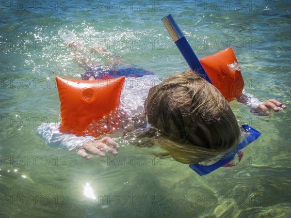 A Child Snorkelling In A Tropical Ocean