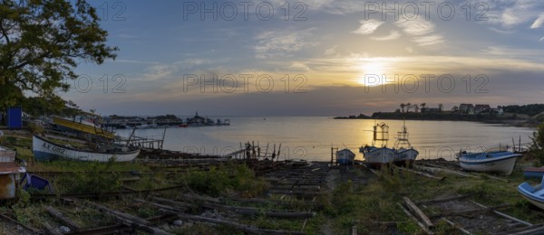 Athopol, Bulgaria, 23 October, 2022: panorama view of the boat ramps and small fishing boats in Athopol harbor on the Black Sea at sunrise