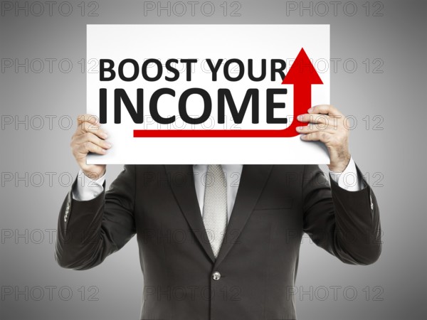 A business man holding a paper in front of his face with the text boost your income