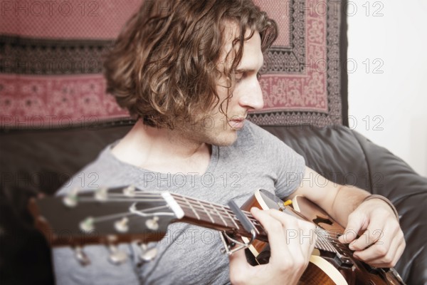 An image of a man playing the guitar