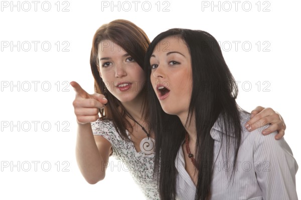 Two young girls see something very funny and laugh
