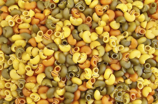 The texture of the yellow, green and orange pasta
