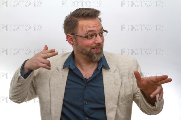 Young man points with finger on light background