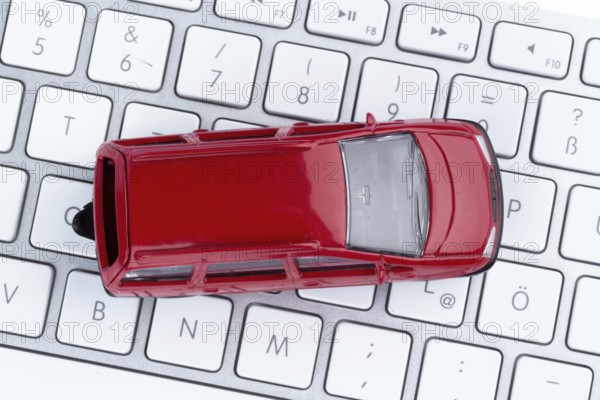 Car on keyboard, symbol photo for car purchase and car trade on the Internet