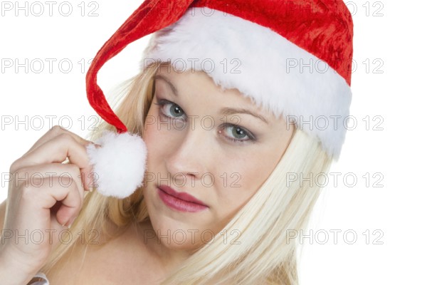 A young woman wearing a Santa hat. Father Christmas in front of a white background. Austria