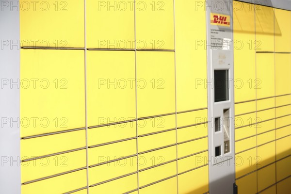 Mainz, Germany - May 27, 2017: Lockers or stacked and lined up parcel boxes with a DHL customer card machine on 27 May 2017 in Mainz