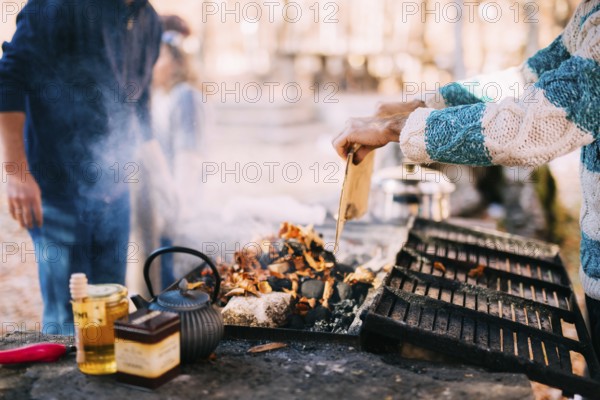 The guy fries a shish kebab on an open fire on a brazier
