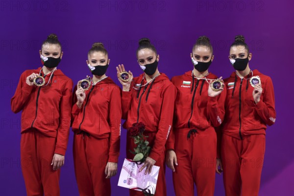 Sofia, Bulgaria - 27 March, 2021: Members of team Bulgaria pose with their gold medals on the podium at Group Apparatus Finals Award Ceremony at the 2021 Rhythmic Gymnastics Sofia World Cup, Sofia, Bulgaria