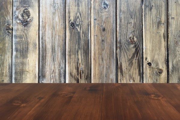 Old brown oak wooden table on the blurry wood wall background, wood table
