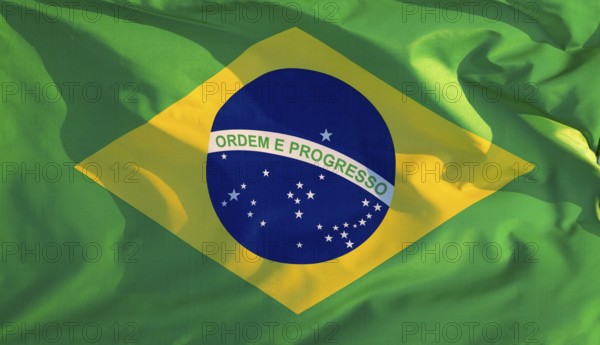Brazil's national flag flutters in the wind in the evening light
