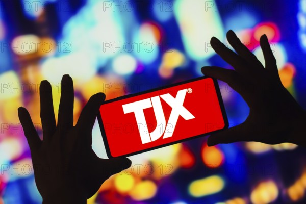 In this photo illustration, the TJX Companies logo is displayed on a smartphone screen