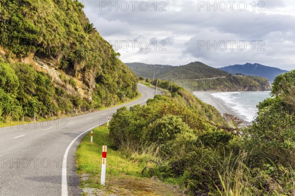 Picturesque road to Pancake Rock - natural wonder of New Zealand. West Coast of the South Island. Cool cloudy day. The concept of ecological, active and photo tourism
