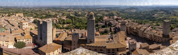 Wide panoramic view over downtown San Gimignano, Torri dei Salvucci and Torre Rognosa in the center, seen from Torre Grosso, Italy