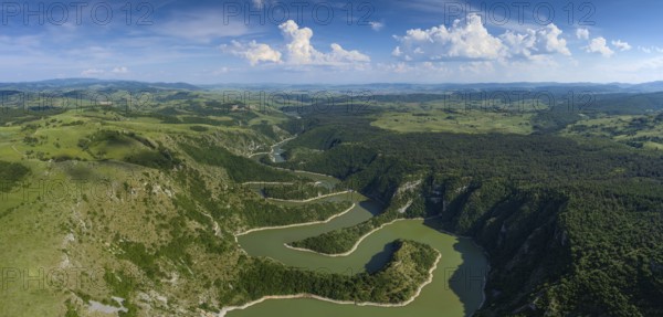 Aerial panorama of meanders at rocky river Uvac gorge on sunny day, southwest Serbia