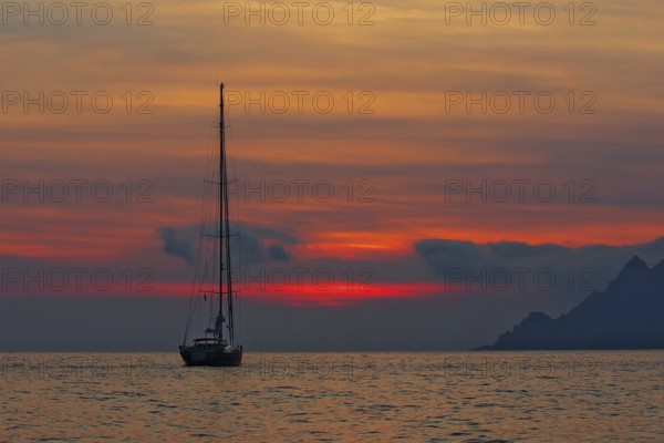Sailing yacht at sunset, Gulf of Porto, Corsica