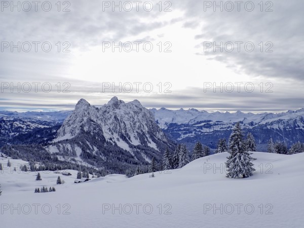 Beautiful winter landscape in central Switzerland. View towards the central Alps with the peaks of the Mythen massive