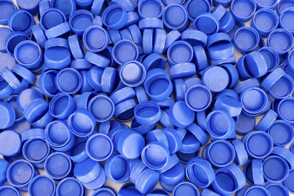 Blue plastic bottle caps. Studio shot. Plastic waste