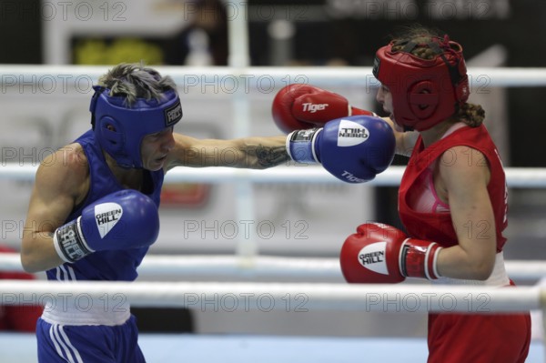 Sofia, Bulgaria - 26 February, 2021: Angelina Lukas (red) of Kazakhstan and Lacramioara Perijoc of Romania fight in their semifinal round of Fly (W51kg) category of the 72-nd International Boxing Tournament Strandja 2021, Sofia, Bulgaria