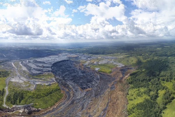 Aerial landscape with coal mine. Environmental disaster - a coal mine dump landslide destroyed a river valley