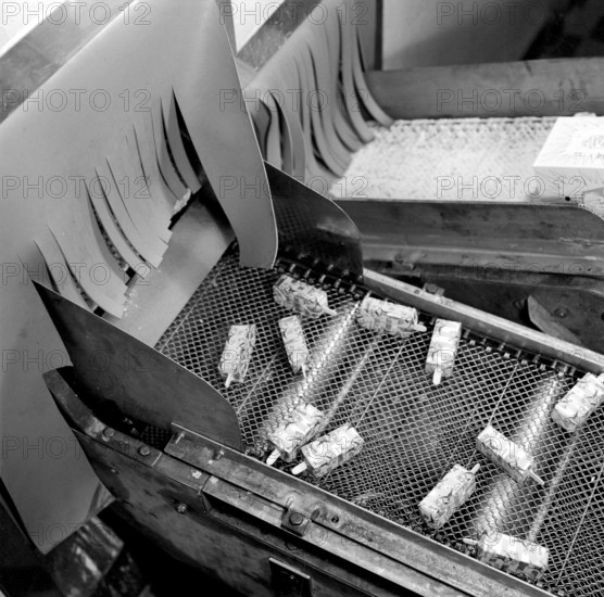Ice Cream in the 1960s. Interior of a ice cream factory when ice cream is produced and is seen in it's finished form, packaged and with a stick. Sweden 1965 ref CS99-5