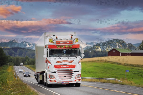 Beautifully customised DAF XF 530 semi trailer Kuljetusliike Jarmo Hieto Oy trucking along highway through beautiful landscape. 2019