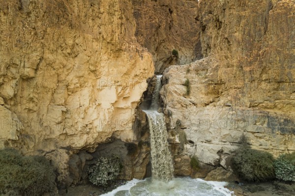 Unexpected powerful waterfall in the Judean Desert around the Dead Sea after heavy winter rains. This is one of the most famous deserts in the world. Shooting from a drone