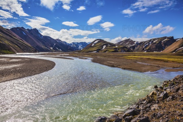 The picturesque valley in the national park Landmannalaugar, Iceland. Summer flood of meltwater flooded the road to a tourist camping