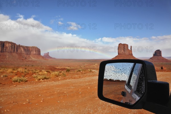Monument Valley in the Navajo Indian Reservation. Arizona, USA. The unique red sandstone buttes are reflected in the car mirror