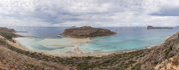 A panorama picture of the blue water of Balos Beach and the nearby landscape of the Gramvousa Peninsula