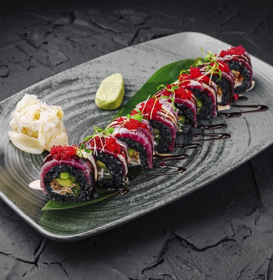 Food, Vibrant sushi rolls are arranged beautifully on a dark plate, showcasing various colors and textures. Garnishes include wasabi and pickled ginger, enhancing the culinary experience