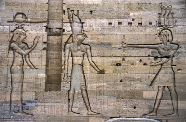 Scanned historical colour photo of relief-like pharaohs and gods carved into a wall in the temple of Karnak, Egypt, Egypt