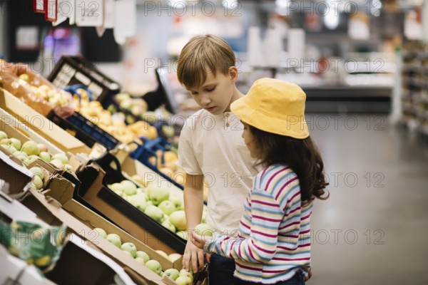 Kinder kleines süßes Mädchen und Teenager Junge Einkaufen für frisches Bio-Obst und Gemüse im Supermarkt