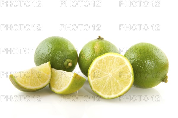 Fresh green limes cut isolated over white