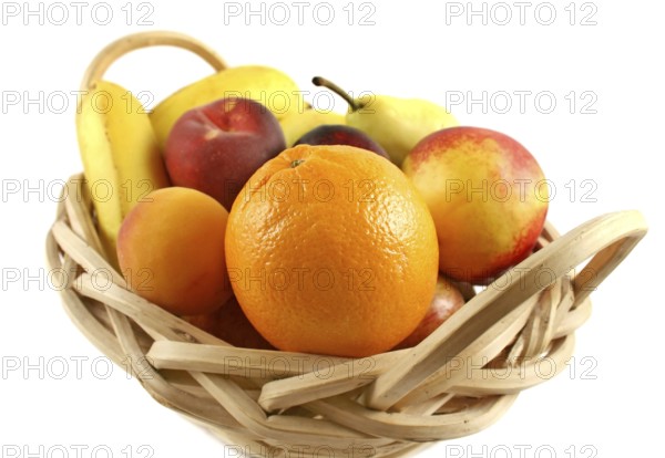 Cane basket filled with freshly picked colorful organic fruit