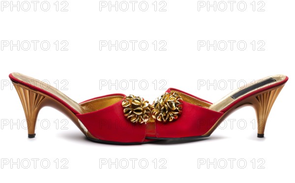 Pair red female shoe with gold brooch. Isolate on white