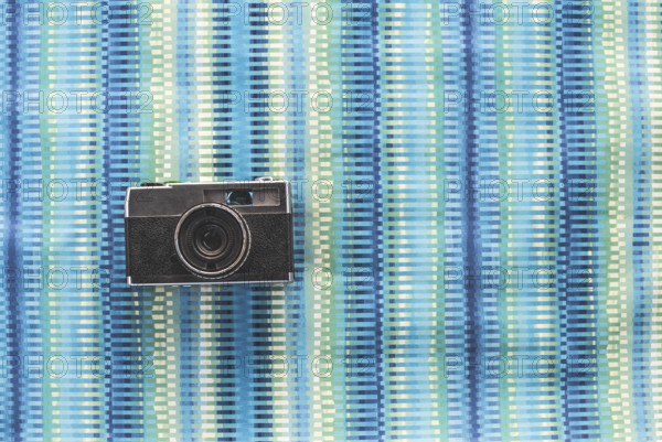 Vintage photocamera on blue paper background