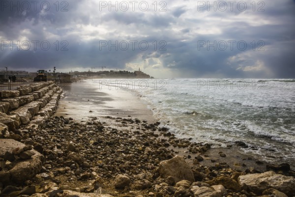 The storm in the Mediterranean Sea. Huge foaming waves beating against the shore. New Quay in the Old Jaffa, Israel