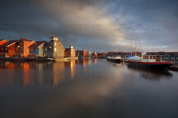 Boats, ships and colorful buildings duirng sunrise at Reitdiephaven, Groningen, Netherlands