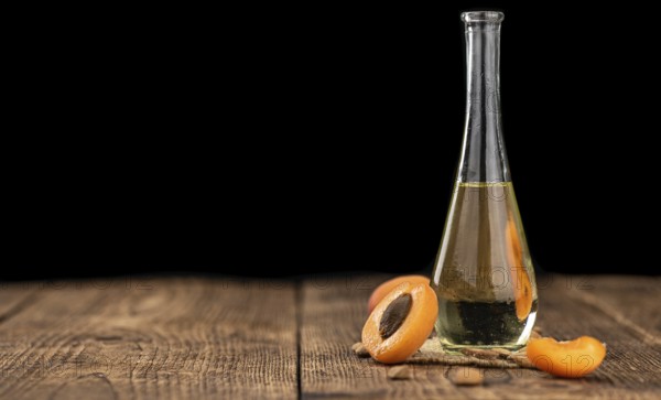 Portion of Apricot Oil with some fresh fruits as detailed close up shot (selective focus)