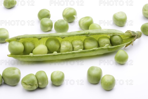 Fresh green peas on a white background