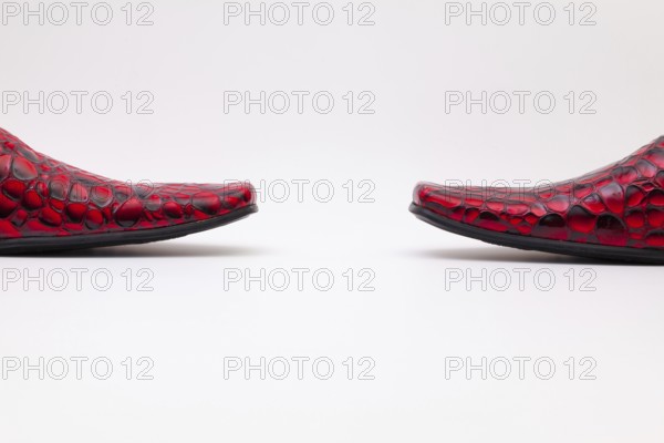 Detail of men's red shoes on white background
