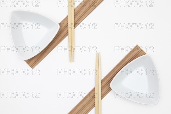 Top View Of White Empty Sushi Plates With Bamboo Chopsticks. Symmetry Food Design