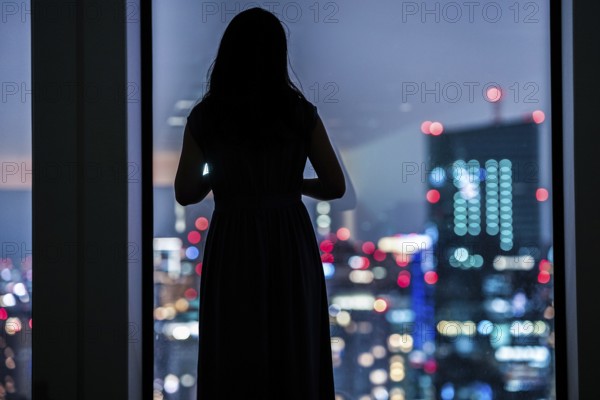 Night view and female silhouette. Shooting Location: Tokyo metropolitan area