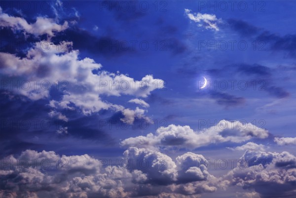 Moon on the sky with curly clouds