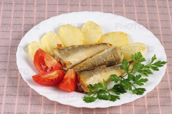 Fried fish and potato dinner on the table