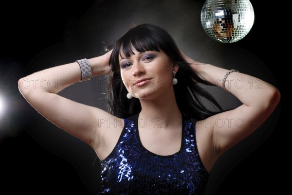 Girl in the nightclub is dancing in lights