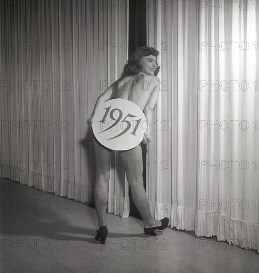 Ballet girl in the 1950s. A young woman on stage holding a sign with the year 1951 printed on it. She is actress Harriet Andersson. Sweden 1951 . Ref Kristoffersson BB10-11