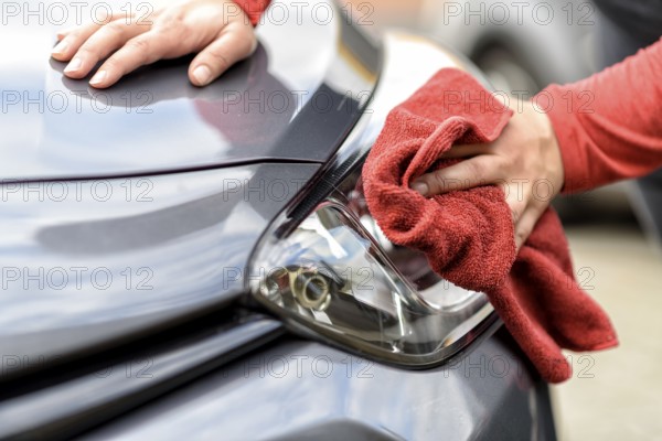 Polishing a car with a cloth after the car wash
