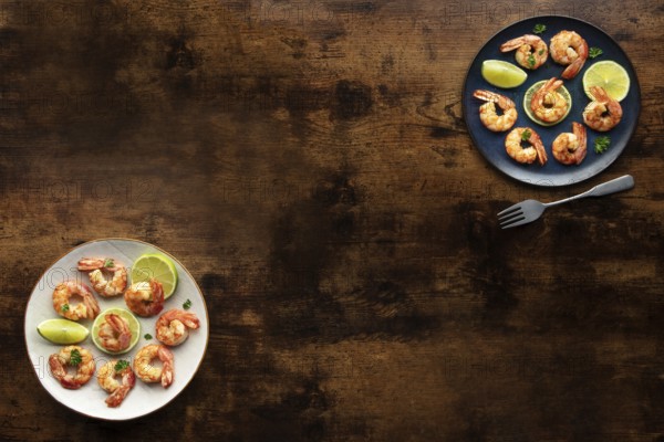 Shrimps, overhead flat lay banner with copy space. Fried shrimp with lime, two plates, shot from the top on a rustic wooden background with a place for text, Food photography, Food photography