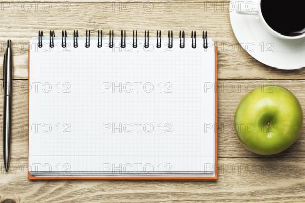 White blank paper with cup of coffee on wooden table